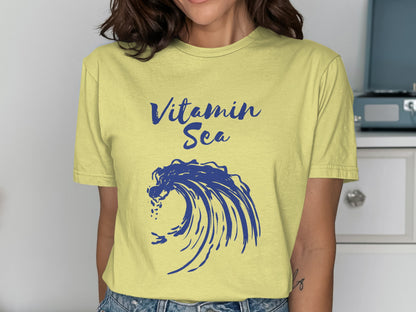 Yellow t-shirt with "Vitamin Sea" text and blue wave graphic.