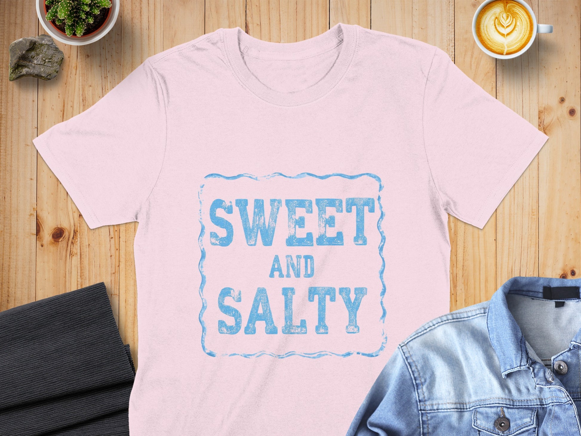 Light pink t-shirt with "SWEET AND SALTY" text in distressed blue lettering.