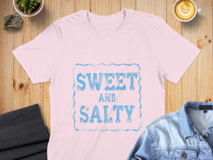 Light pink t-shirt with "SWEET AND SALTY" text in distressed blue lettering.
