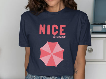Navy t-shirt with "NICE CÔTE D'AZUR" and pink umbrella graphic.