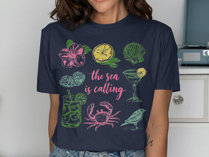 Navy t-shirt with "The sea is calling" text and beach-themed illustrations.