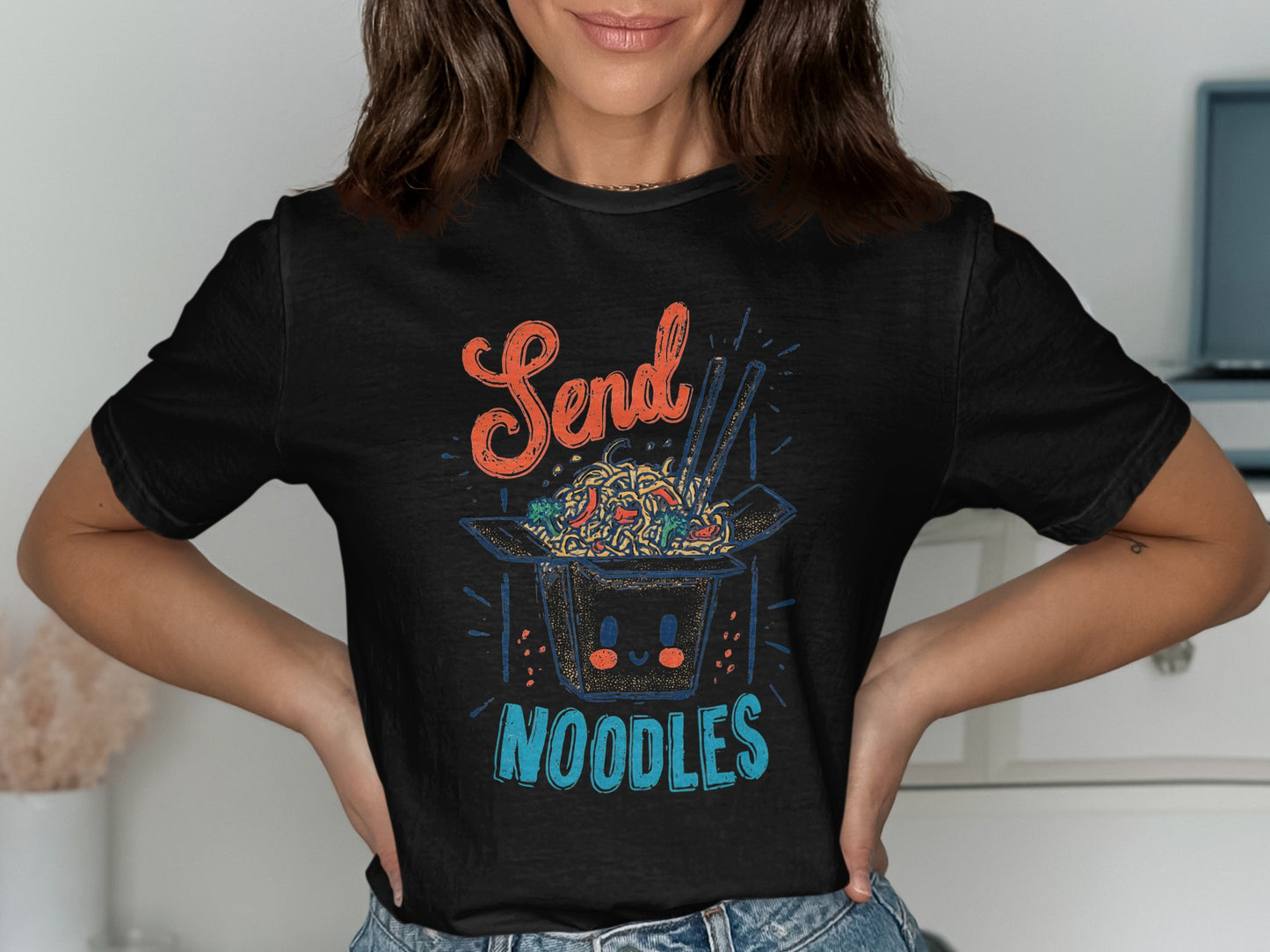 Black t-shirt with a graphic of a smiling noodle bowl and the text "Send Noodles".