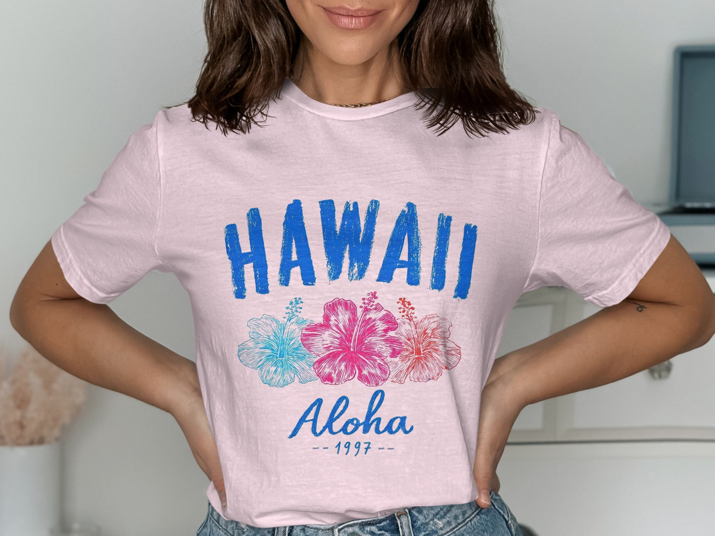 Pink t-shirt with "HAWAII Aloha - 1997" and floral graphic.