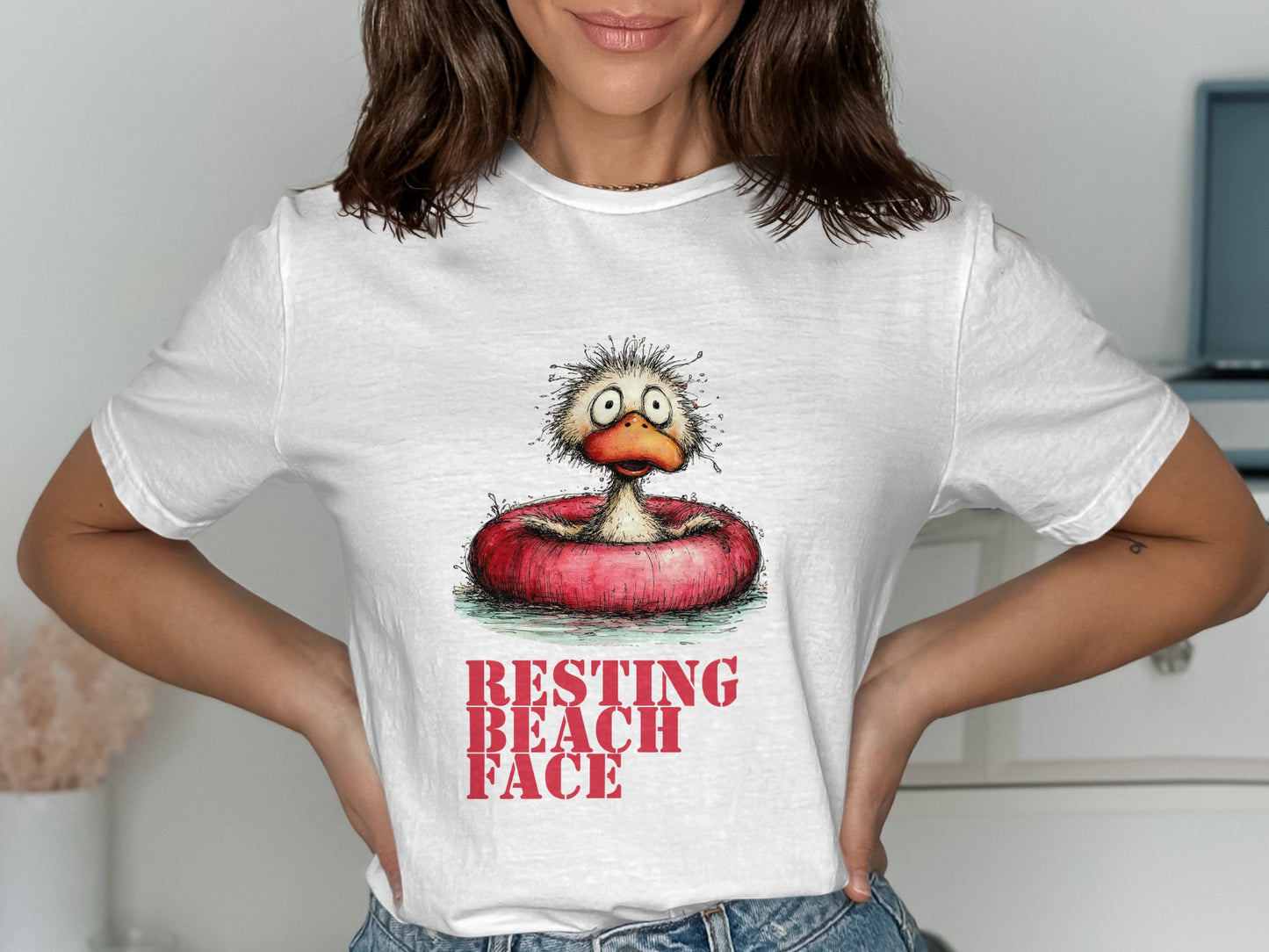 White t-shirt with cartoon duck in a float and text "RESTING BEACH FACE".