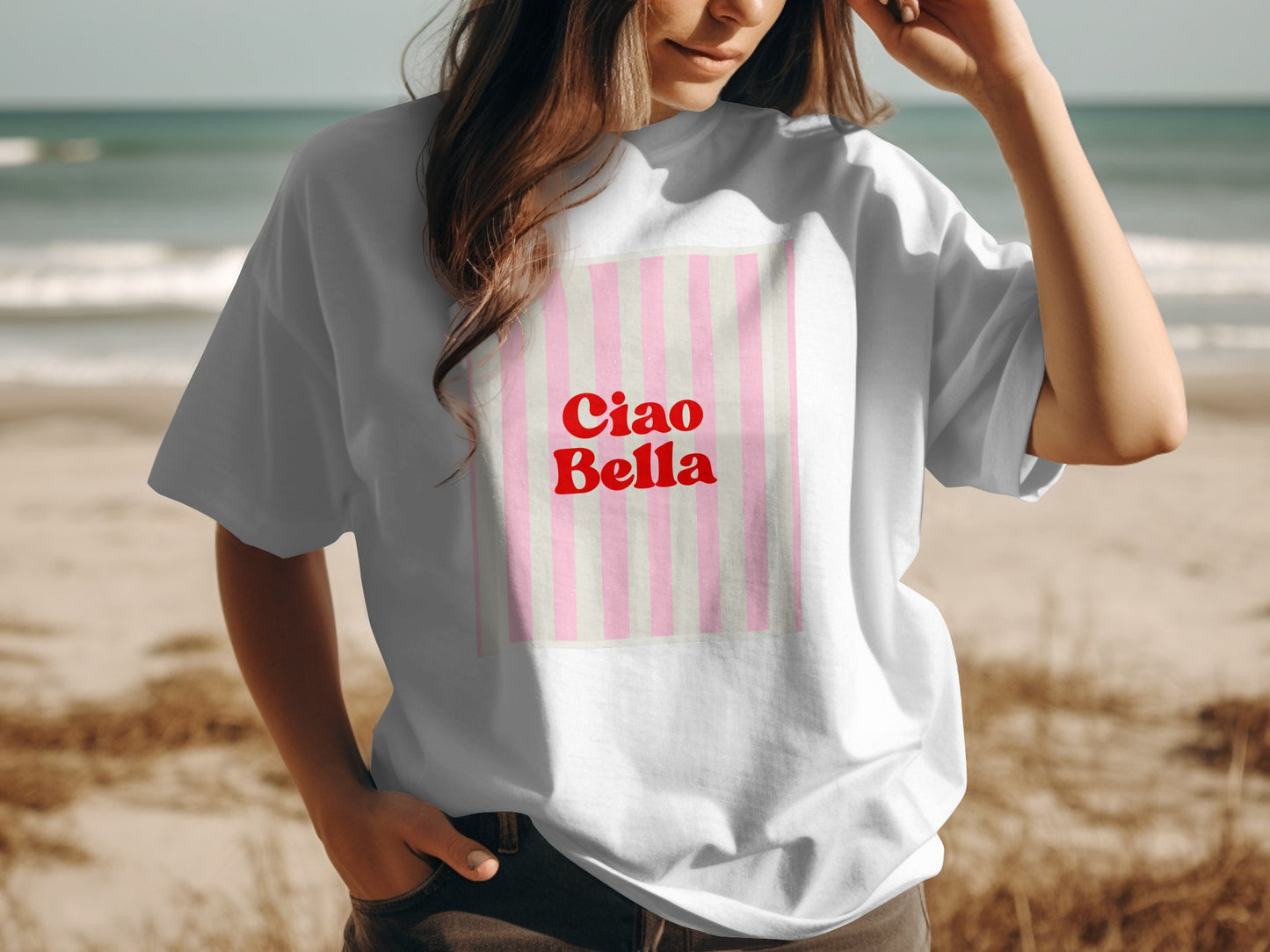 White t-shirt with "Ciao Bella" text on a pink and white striped background.