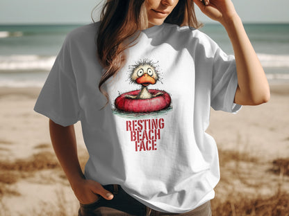 White t-shirt with distressed cartoon duck in inflatable ring saying "RESTING BEACH FACE".