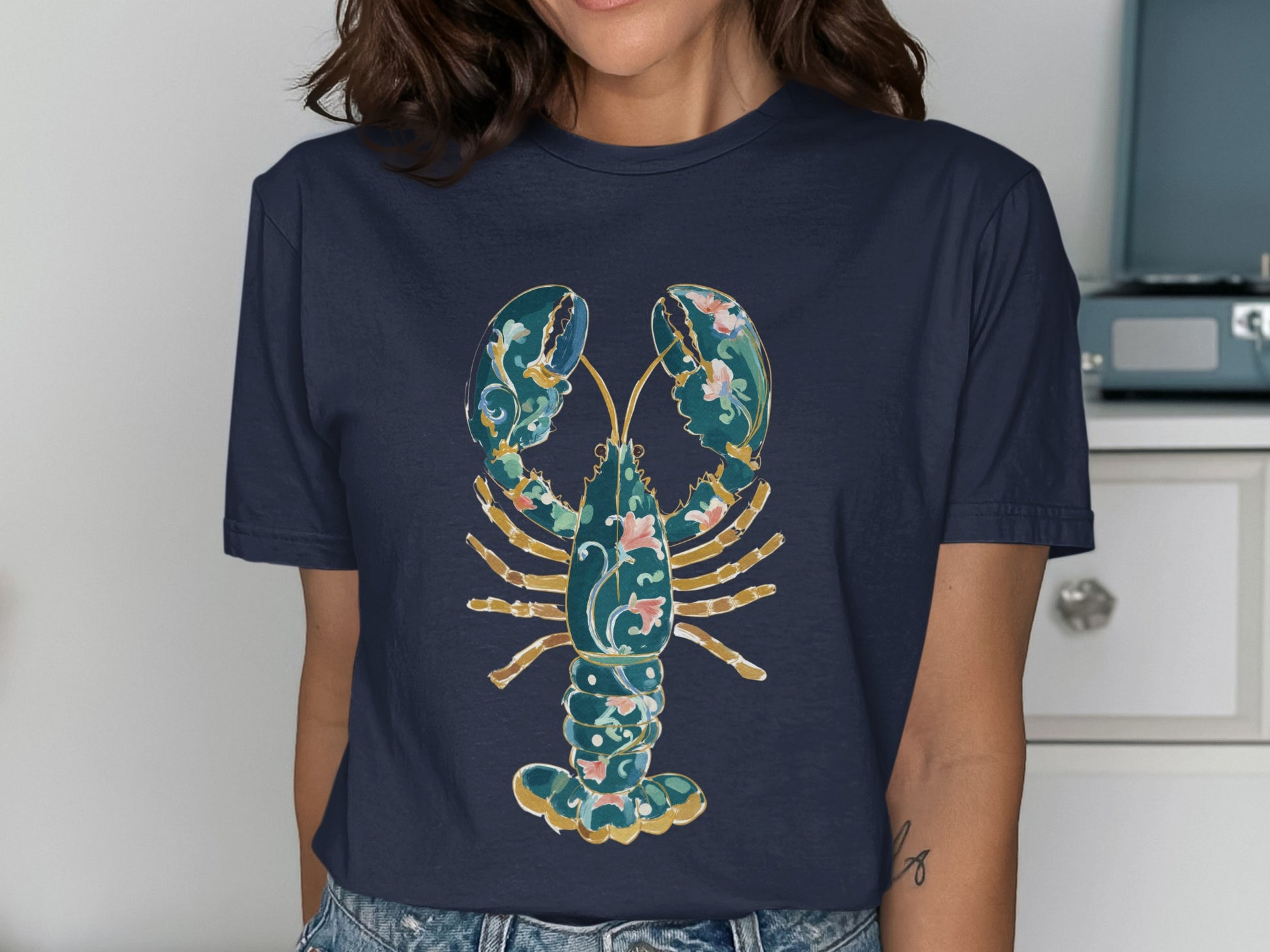 Navy t-shirt with a decorative blue and gold lobster graphic.