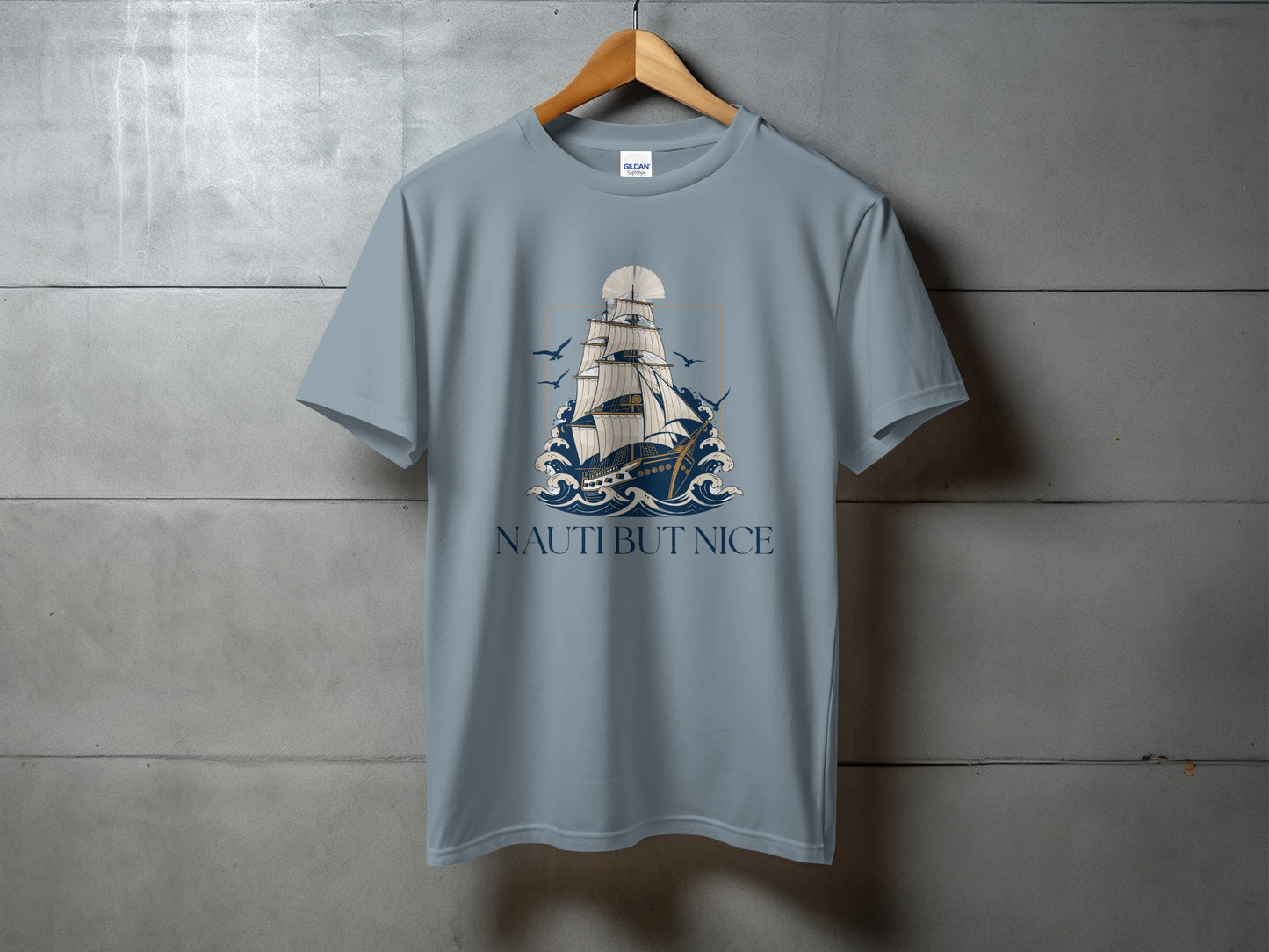 Gray t-shirt with sailing ship, waves, and text "NAUTI BUT NICE".