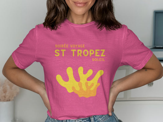 Pink t-shirt with "Soirée Voyage St. Tropez Soleil" and coral graphic.