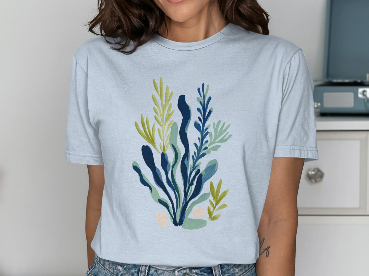 Light blue t-shirt with abstract blue and green botanical print.