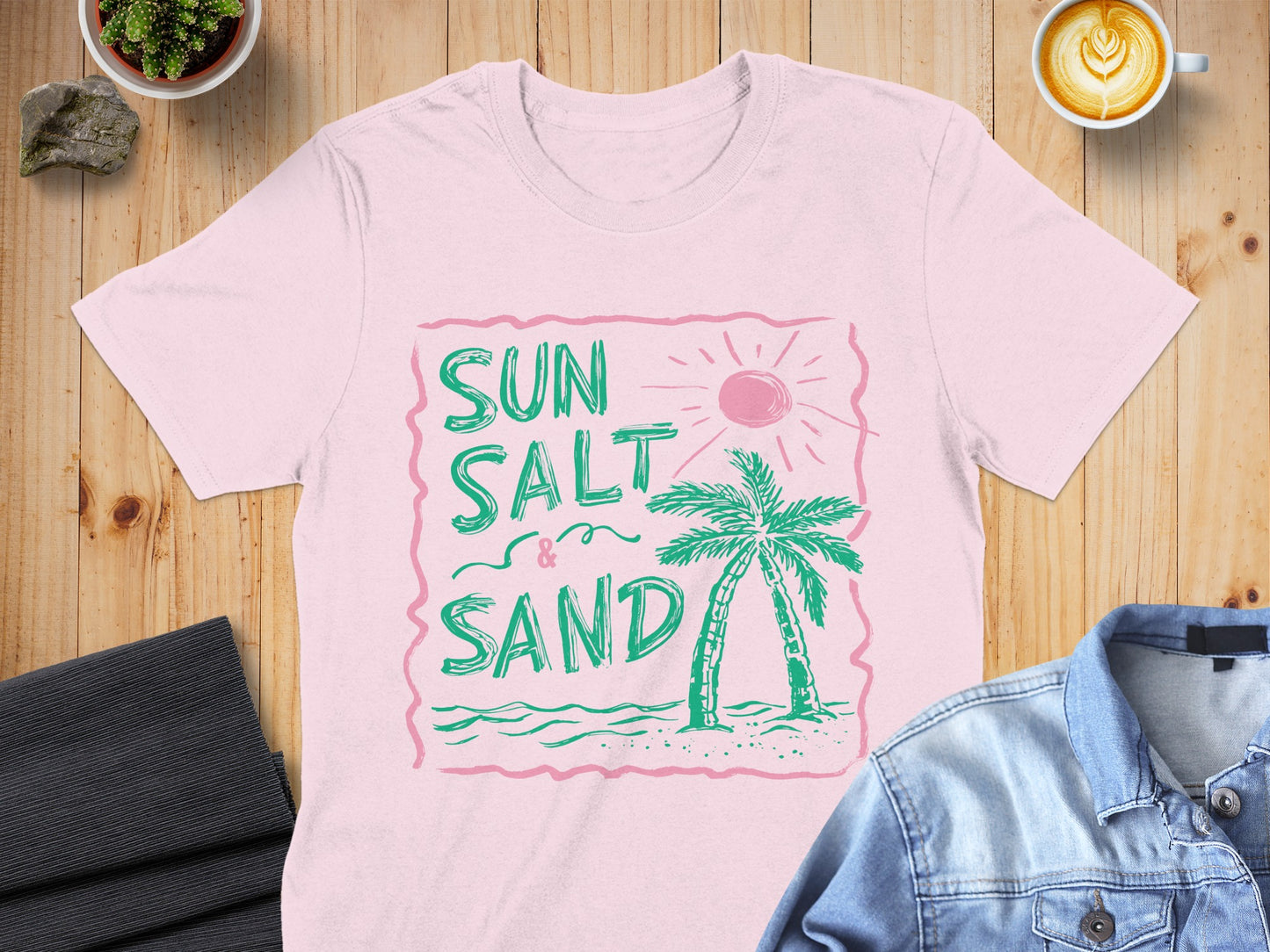 Pink t-shirt with "Sun Salt & Sand" text, palm tree, and sun graphic.