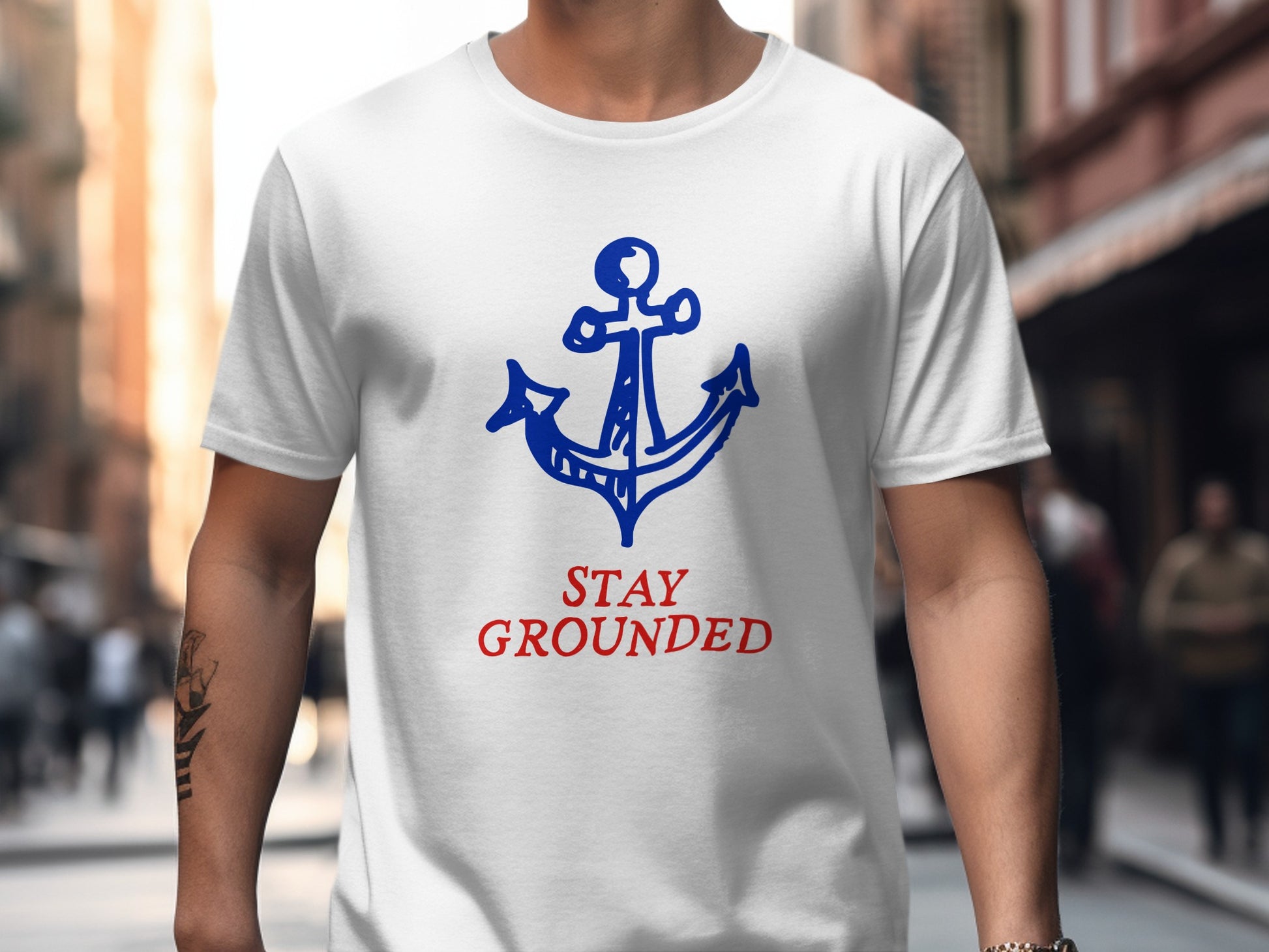 White t-shirt with blue anchor and red "STAY GROUNDED" text.