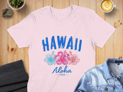 Pink t-shirt with "HAWAII Aloha - 1997" text and hibiscus flowers.