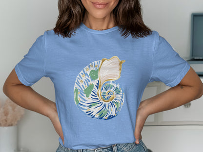 Light blue t-shirt with a watercolor nautilus shell graphic.