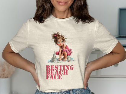 T-shirt with illustration of a girl building a sandcastle, text "RESTING BEACH FACE".