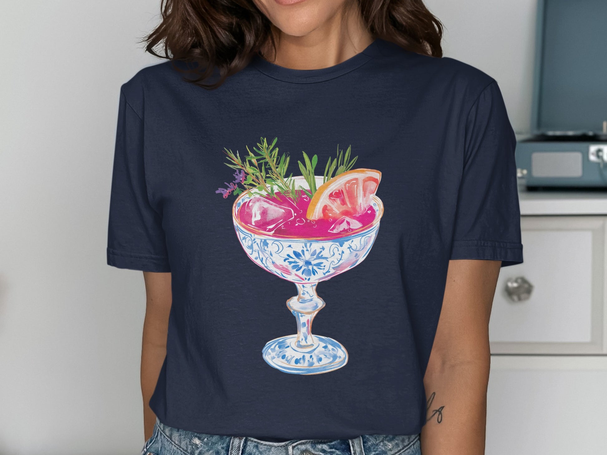 Cocktail with grapefruit slice and herbs in decorative glass.