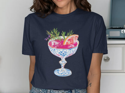 Cocktail with grapefruit slice and herbs in decorative glass.