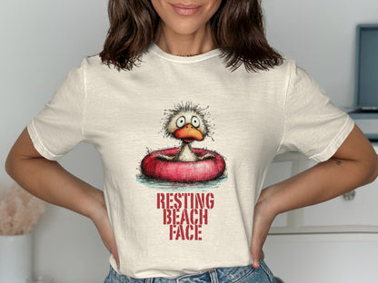 Cream t-shirt with distressed graphic of a cartoon duck in a float, reading "RESTING BEACH FACE".