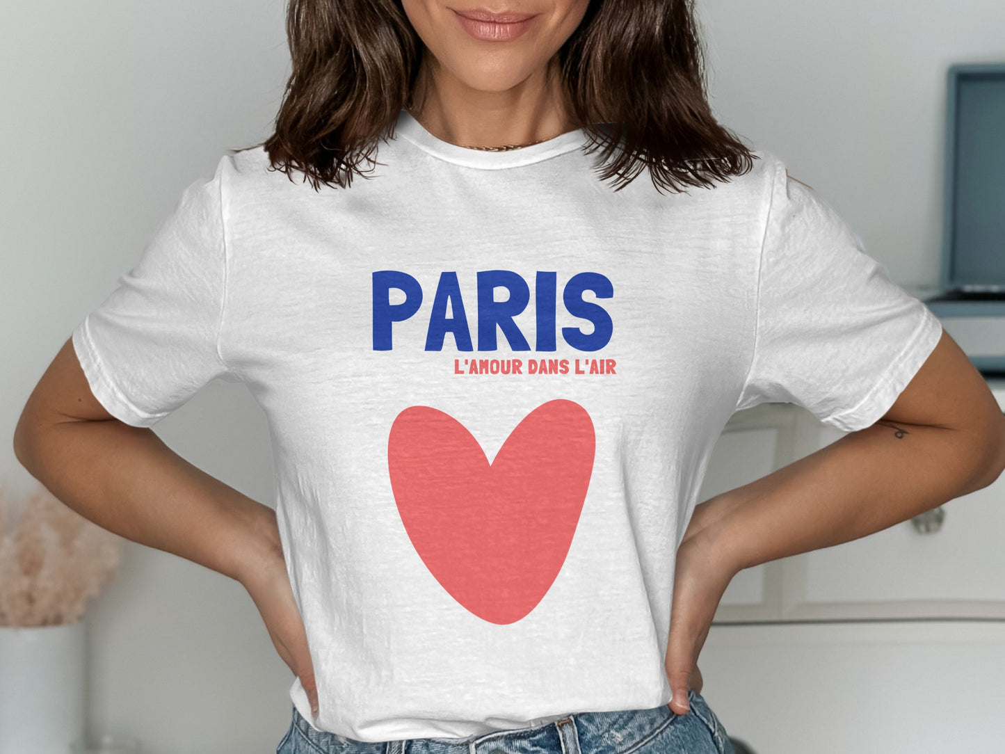 White t-shirt with "PARIS L'AMOUR DANS L'AIR" and a red heart.