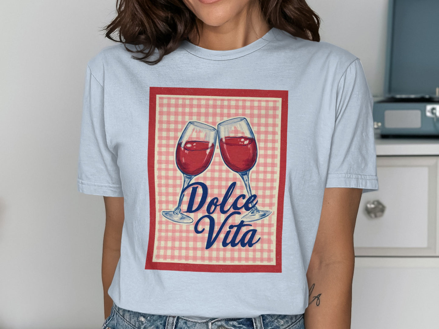 Two wine glasses clinking with "Dolce Vita" text on a checkered background.