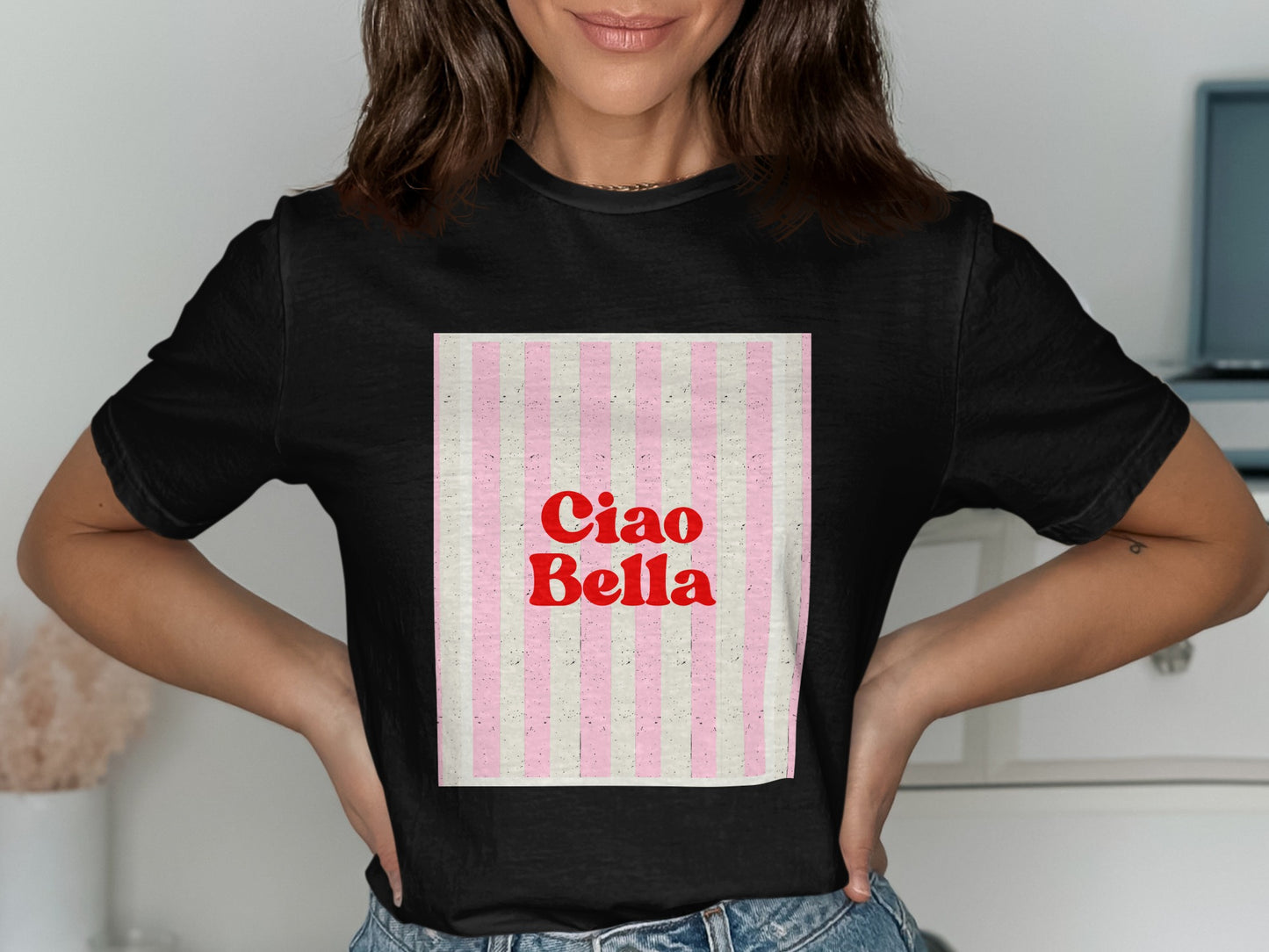 Black t-shirt with "Ciao Bella" text on a pink and white striped background.