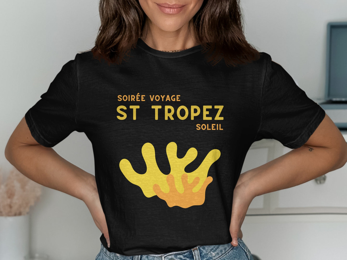 Black t-shirt with "Soirée Voyage St. Tropez Soleil" and coral graphic.