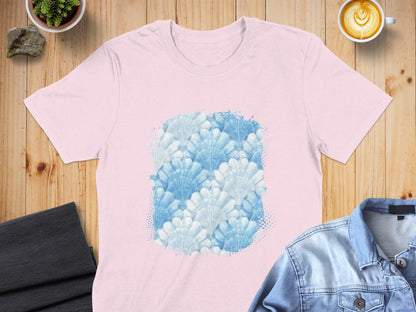 Pink t-shirt with a pattern of white and blue fan-shaped leaves.