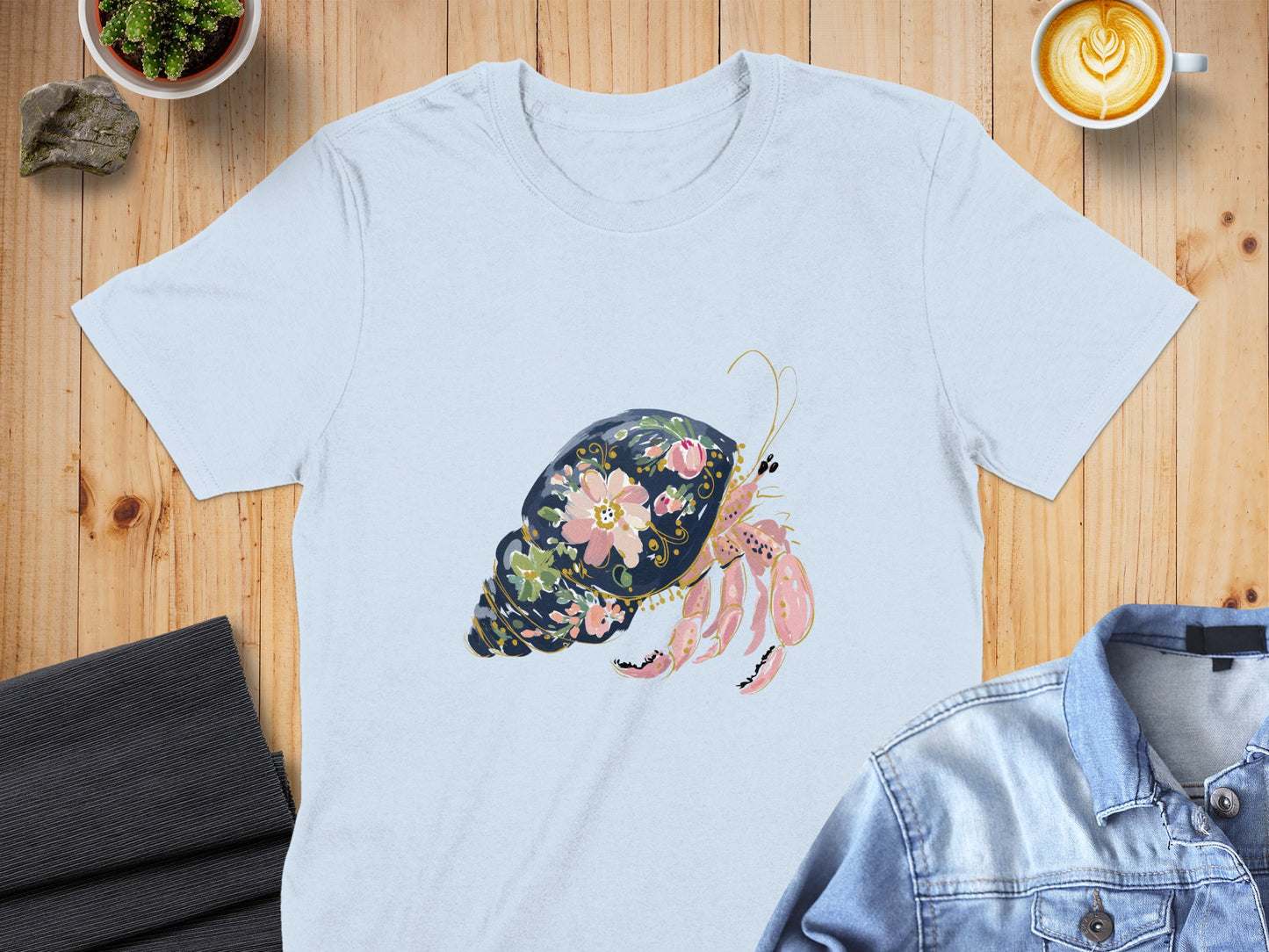 Light blue t-shirt with a hermit crab and floral shell design.