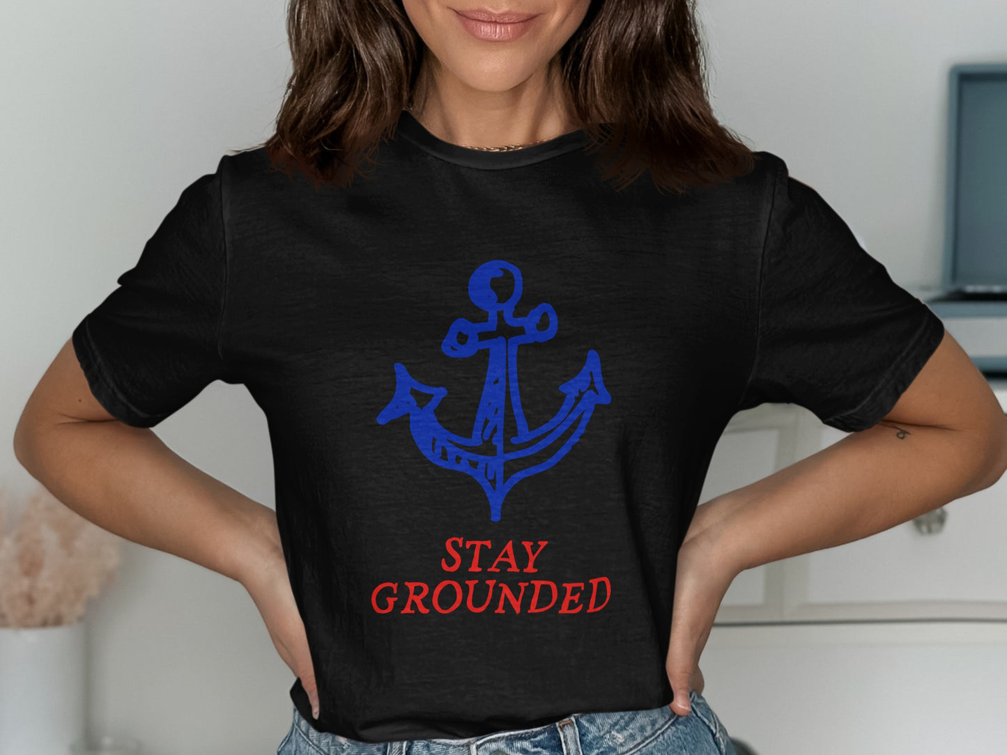 Black t-shirt with blue anchor and red "STAY GROUNDED" text.