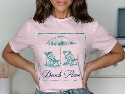 Pink t-shirt with a sketched beach scene of two chairs and an umbrella, text reads "Beach Please".