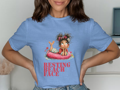 T-shirt with graphic of girl relaxing on inflatable ring, reads "RESTING BEACH FACE".