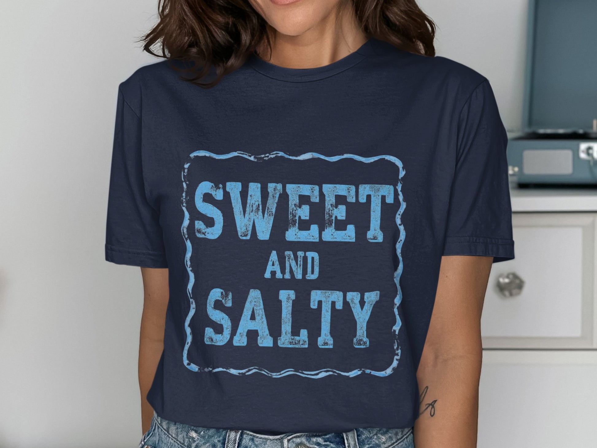 Navy blue t-shirt with "SWEET AND SALTY" text in distressed blue font.