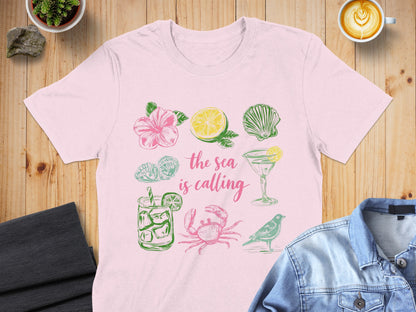 Pink t-shirt with hand-drawn sea-themed illustrations and text.