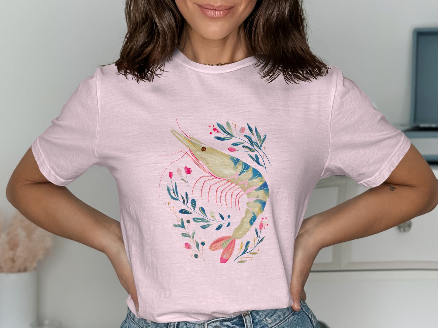 Pink t-shirt with a watercolor shrimp and floral illustration.