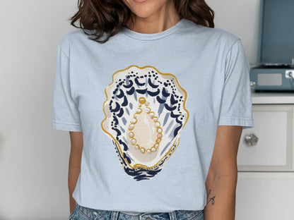 Light blue t-shirt with a painted oyster shell and pearl design.