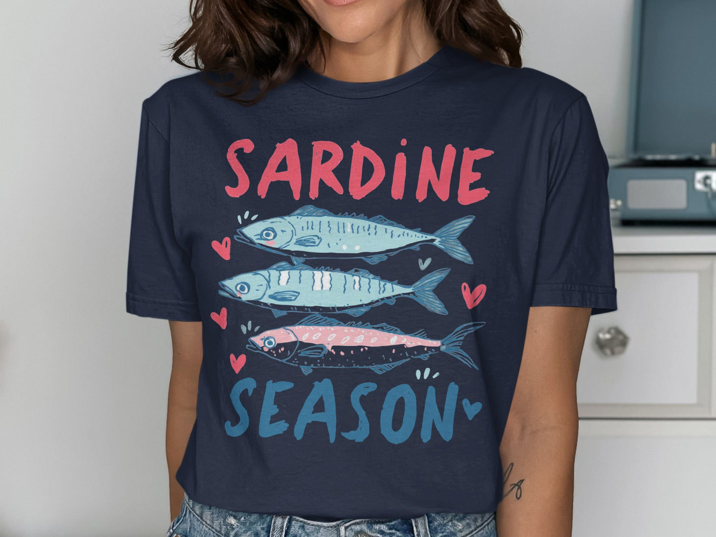 Navy t-shirt with "SARDINE SEASON" and three stylized sardines.