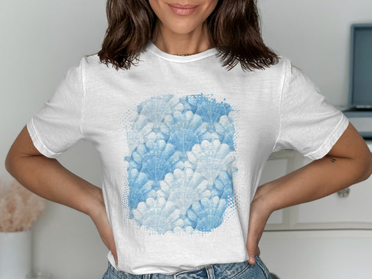 White t-shirt with a repeating pattern of blue seashell graphics.