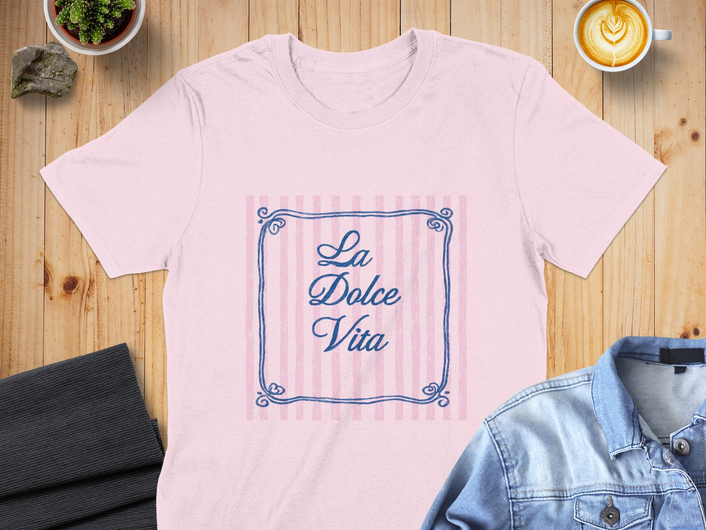 Pink t-shirt with "La Dolce Vita" text within a striped frame.