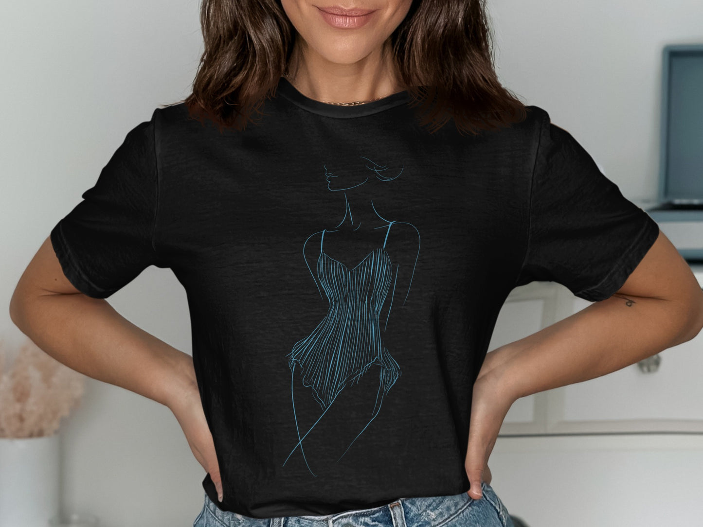 Black t-shirt with a blue outline drawing of a woman's silhouette in a dress.