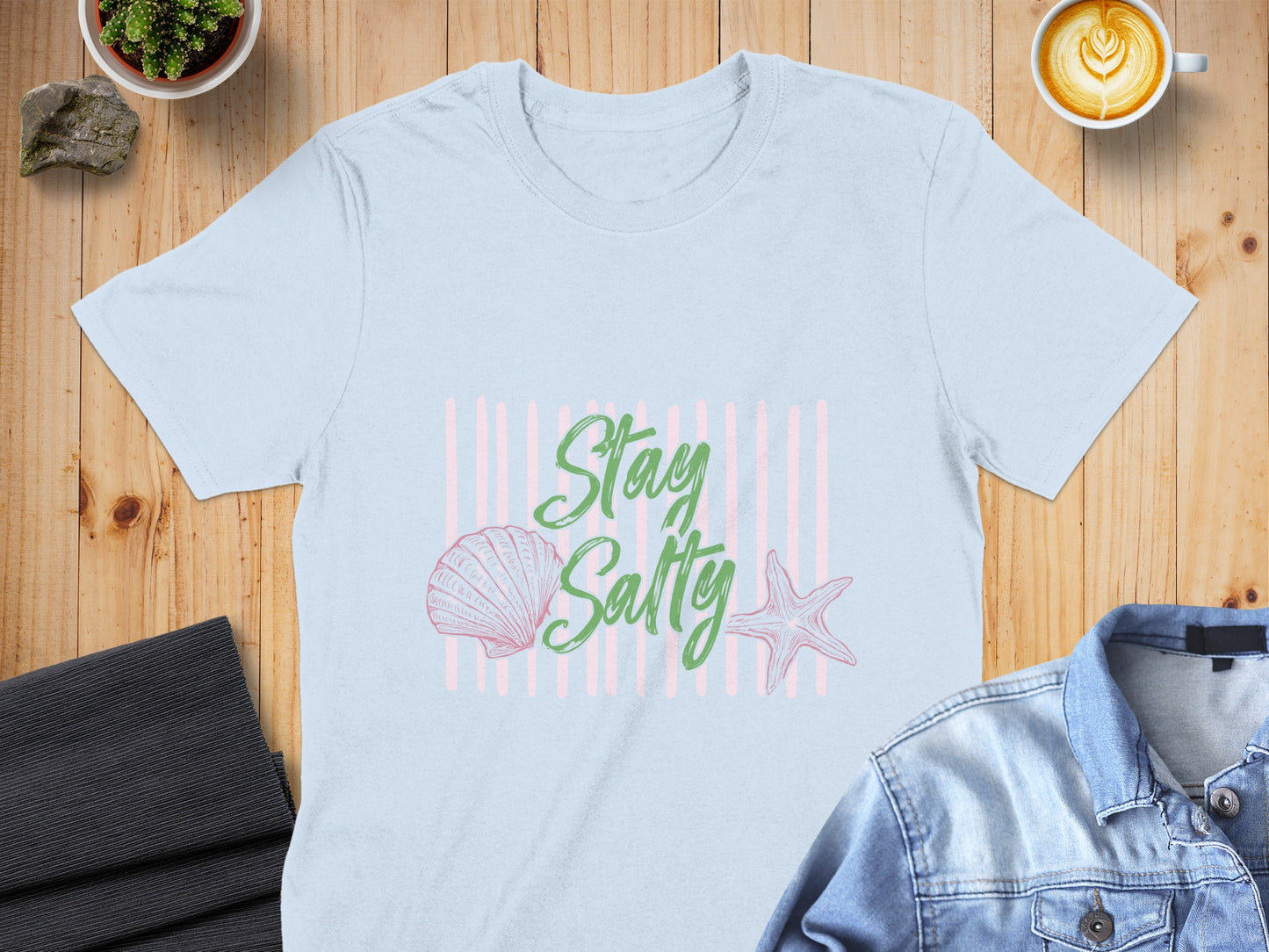 Light blue t-shirt with "Stay Salty" text, seashell, and starfish design.