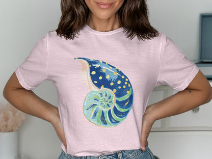 Pink t-shirt with a watercolor nautilus shell graphic.