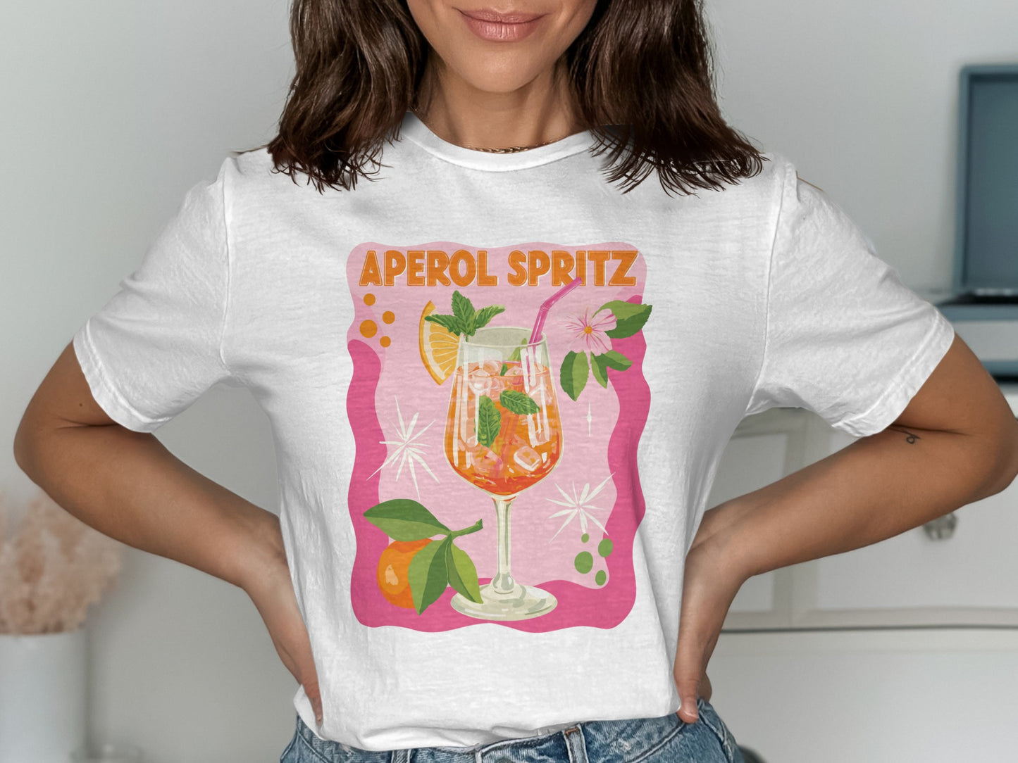 White t-shirt featuring a graphic of an Aperol Spritz cocktail.