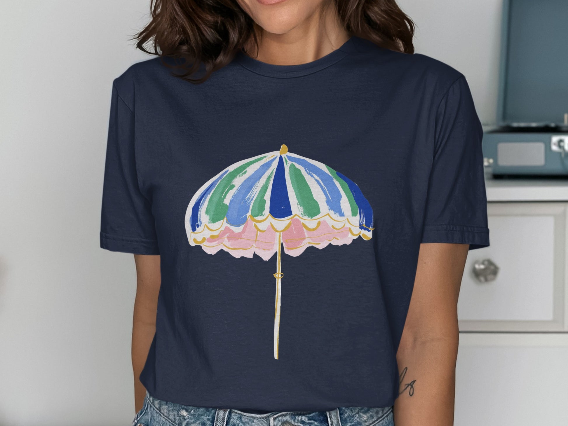 Navy t-shirt with a colorful beach umbrella graphic featuring pink, green, and blue stripes.