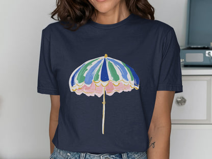 Navy t-shirt with a colorful beach umbrella graphic featuring pink, green, and blue stripes.