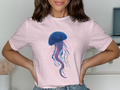 Pink t-shirt with a blue and purple jellyfish graphic.