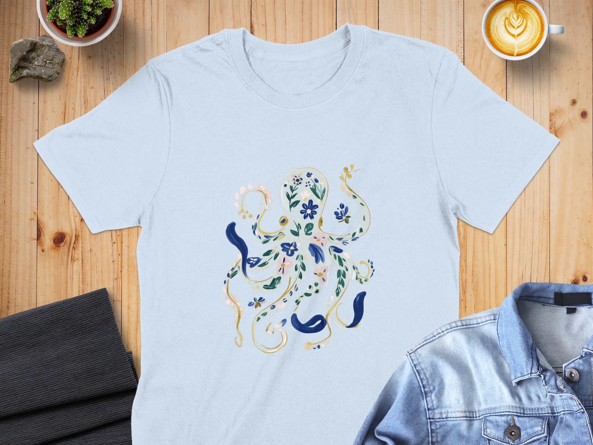 Light blue t-shirt with an illustration of an octopus made of flowers and leaves.