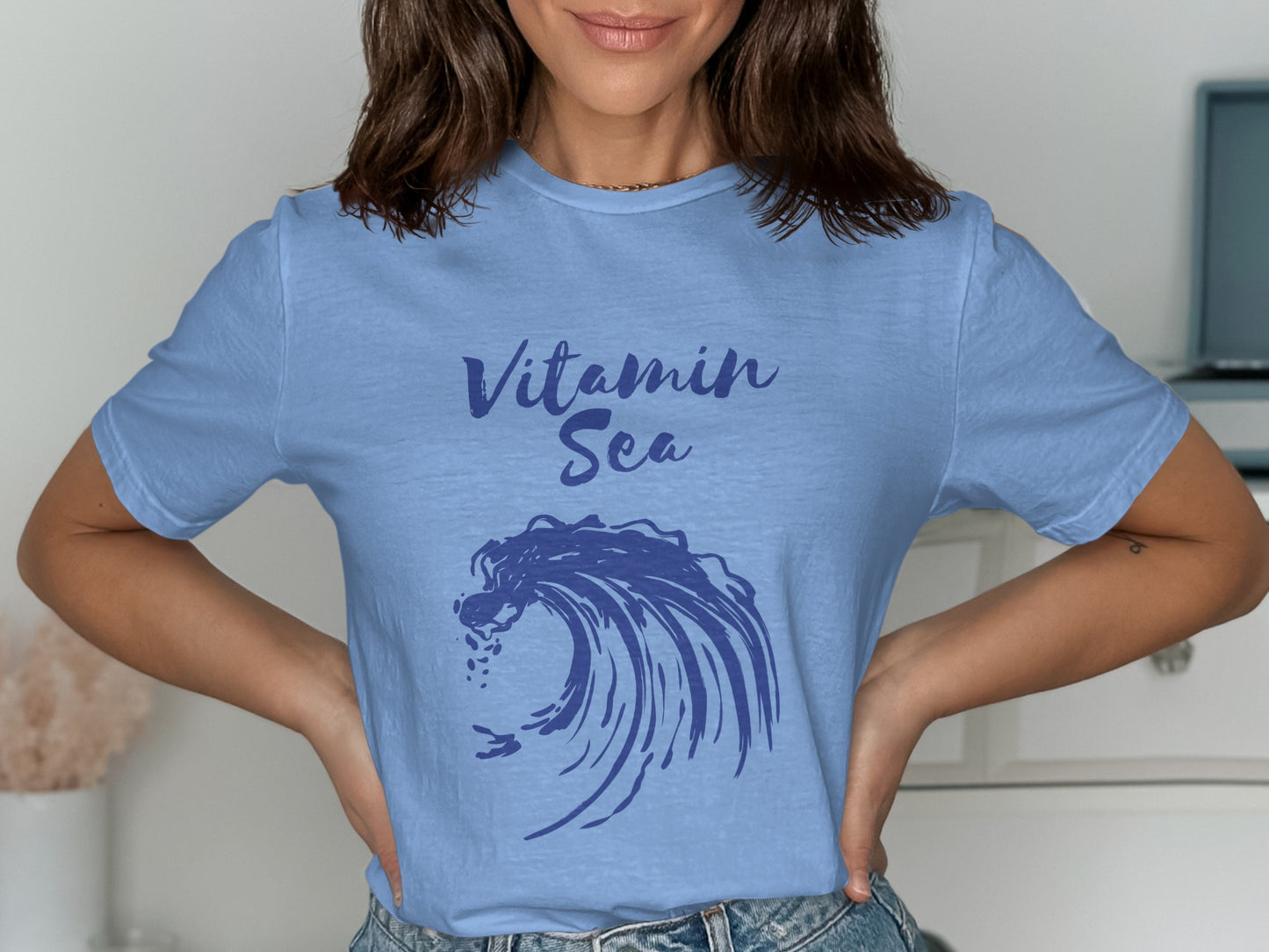 Light blue t-shirt with "Vitamin Sea" text and a blue wave graphic.