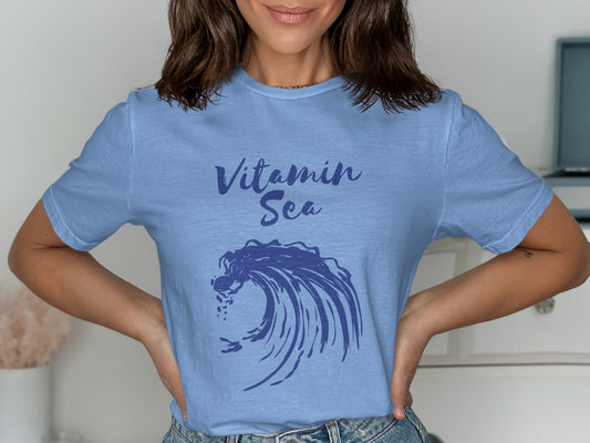 Light blue t-shirt with "Vitamin Sea" text and a blue wave graphic.