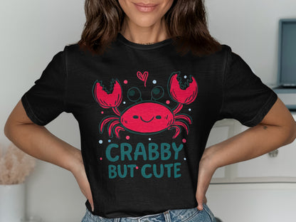 Black t-shirt with smiling crab graphic and text "CRABBY BUT CUTE".