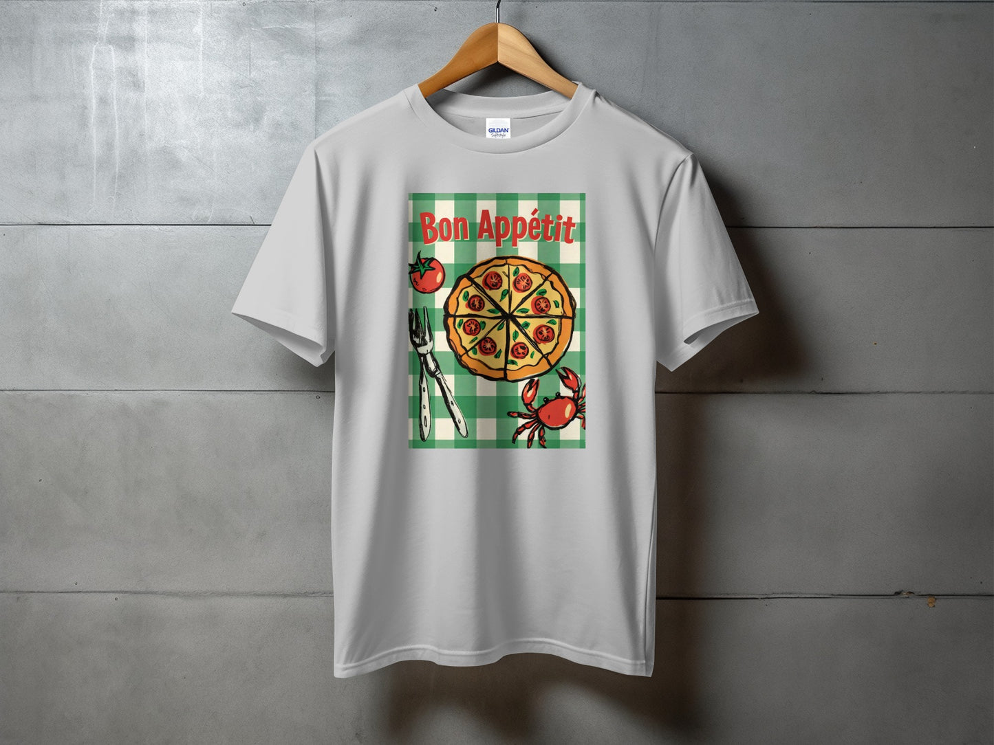 White t-shirt with "Bon Appétit" text above a pizza slice and crab illustration.